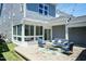 Backyard patio with blue outdoor seating, string lights, and partial view of home exterior at 1223 Brown Velvet Ln, Apex, NC 27523