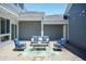 Backyard patio with blue outdoor seating, string lights, and view of home exterior at 1223 Brown Velvet Ln, Apex, NC 27523