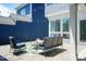 Backyard patio area with blue seating, string lights, and view of house exterior at 1223 Brown Velvet Ln, Apex, NC 27523