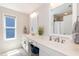 Bathroom featuring double sinks, a large window, and modern fixtures at 1223 Brown Velvet Ln, Apex, NC 27523