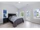 Bedroom with wood floors, a large bed, and lots of natural light at 1223 Brown Velvet Ln, Apex, NC 27523