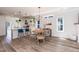 Open dining area connected to the kitchen with modern light fixture at 1223 Brown Velvet Ln, Apex, NC 27523