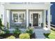 Inviting front porch with chairs and beautiful landscaping at 1223 Brown Velvet Ln, Apex, NC 27523