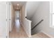 Hallway with wood floors, white walls, and natural light at 1223 Brown Velvet Ln, Apex, NC 27523