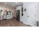 Bright kitchen with stainless steel refrigerator, white cabinets, and view to open living area at 1223 Brown Velvet Ln, Apex, NC 27523