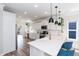Modern kitchen with quartz countertops, stainless steel appliances, and stylish pendant lighting at 1223 Brown Velvet Ln, Apex, NC 27523