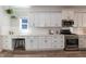 Open kitchen featuring stainless steel appliances, white cabinets, and a subway backsplash at 1223 Brown Velvet Ln, Apex, NC 27523