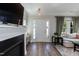 Bright living room with a fireplace, hardwood floors, and a view of the front entrance at 1223 Brown Velvet Ln, Apex, NC 27523