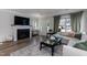 Cozy living room with fireplace, hardwood floors, and natural light at 1223 Brown Velvet Ln, Apex, NC 27523
