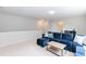 Living room featuring a plush sectional, neutral walls, and a view to the hall at 1223 Brown Velvet Ln, Apex, NC 27523