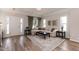 Inviting living room with a neutral palette, wood floors, and lots of natural light at 1223 Brown Velvet Ln, Apex, NC 27523