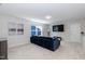 Living room featuring plush blue sectional, large window, and neutral walls at 1223 Brown Velvet Ln, Apex, NC 27523