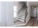 Staircase with wood railing, white risers, and wood flooring at 1223 Brown Velvet Ln, Apex, NC 27523