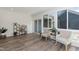 Sunroom with large windows, wood flooring, and neutral decor at 1223 Brown Velvet Ln, Apex, NC 27523