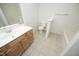 Well-lit bathroom features a vanity, toilet, and bathtub, offering a clean and functional space at 12306 Mossgreen St, Raleigh, NC 27614