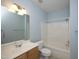 Bathroom with single sink vanity and tub with shower at 12306 Mossgreen St, Raleigh, NC 27614