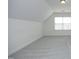 A spacious carpeted bedroom with a window offers a serene and comfortable retreat at 12306 Mossgreen St, Raleigh, NC 27614