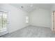 Bright bedroom featuring vaulted ceiling, neutral carpet, and walk-out at 12306 Mossgreen St, Raleigh, NC 27614