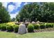 Community green space featuring decorative rock feature surrounded by lush landscaping at 12306 Mossgreen St, Raleigh, NC 27614