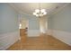 Formal dining room with beautiful hardwood floors, wainscoting, and chandelier at 12306 Mossgreen St, Raleigh, NC 27614