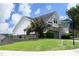 Corner lot home featuring a side entry garage and lush lawn, complemented by street signage at 12306 Mossgreen St, Raleigh, NC 27614