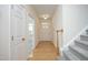 Bright foyer with hardwood floors, staircase, and white doors creating a welcoming entry at 12306 Mossgreen St, Raleigh, NC 27614