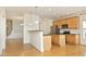 Open kitchen with stainless steel appliances, granite countertops, and an island bar at 12306 Mossgreen St, Raleigh, NC 27614