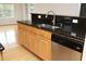 Kitchen bar showcasing stainless steel appliances, dark granite countertops, and wood cabinets at 12306 Mossgreen St, Raleigh, NC 27614