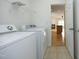 Functional laundry room with washer, dryer, and shelving provides efficient organization at 12306 Mossgreen St, Raleigh, NC 27614