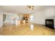 Open-concept living space with hardwood floors, fireplace and modern kitchen at 12306 Mossgreen St, Raleigh, NC 27614