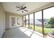Enjoy outdoor living in this screened porch, complete with a ceiling fan and serene backyard views at 12306 Mossgreen St, Raleigh, NC 27614