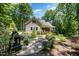 Beautifully landscaped backyard with patio and fire pit area and wooded backdrop at 12733 Pamplona Dr, Wake Forest, NC 27587