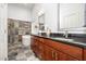 Bathroom featuring a soaking tub, glass enclosed shower, and wood vanity with dual sinks and modern fixtures at 12733 Pamplona Dr, Wake Forest, NC 27587
