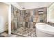 Modern bathroom featuring a freestanding tub and a walk-in shower with glass enclosure and tile surround at 12733 Pamplona Dr, Wake Forest, NC 27587