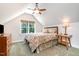 Cozy bedroom featuring a dormer window, sloped ceiling, and neutral decor with a classic wooden dresser at 12733 Pamplona Dr, Wake Forest, NC 27587