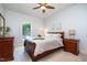 Bedroom with a wooden bed frame, neutral color scheme, and a bright window providing natural light at 12733 Pamplona Dr, Wake Forest, NC 27587