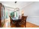 Dining area featuring wood floors, wainscoting, and a modern chandelier at 12733 Pamplona Dr, Wake Forest, NC 27587