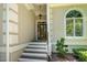 Elegant front entrance with brick steps, decorative columns, and a glass-paneled door at 12733 Pamplona Dr, Wake Forest, NC 27587