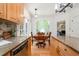 Open kitchen layout with wood cabinets, granite countertops, and access to the living room at 12733 Pamplona Dr, Wake Forest, NC 27587