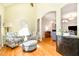 Comfortable living room showcasing high ceilings, hardwood floors, and a decorative archway leading to another living space at 12733 Pamplona Dr, Wake Forest, NC 27587