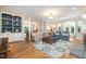 Spacious living room featuring hardwood floors, built-in shelving, and elegant furnishings at 12733 Pamplona Dr, Wake Forest, NC 27587