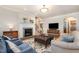Cozy living room with a fireplace, plush seating, and a large television at 12733 Pamplona Dr, Wake Forest, NC 27587