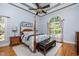 Elegant bedroom featuring a four-poster bed, arched window with natural light, and a decorative ceiling at 12733 Pamplona Dr, Wake Forest, NC 27587