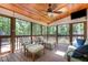 Relaxing screened-in porch featuring wood ceilings, ceiling fan, and outdoor views at 12733 Pamplona Dr, Wake Forest, NC 27587