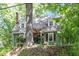 Quaint home featuring a brick chimney, complemented by lush greenery and a stone staircase at 1314 Glendale Ave, Durham, NC 27701