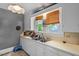 Bright kitchen area featuring ample counter space, a double sink, and a view of the outdoors through charming window at 1314 Glendale Ave, Durham, NC 27701