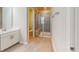Bathroom featuring a glass shower enclosure with built in bench and neutral toned ceramic tile at 1314 Rosepine Dr, Cary, NC 27519