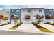 Row of newly constructed townhomes with garages and balconies and beautifully landscaped front yards at 1314 Rosepine Dr, Cary, NC 27519
