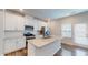 Modern kitchen with stainless steel appliances, white cabinets, and large island at 1314 Rosepine Dr, Cary, NC 27519