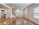 Open living room with staircase, bright lighting, and wood flooring at 1314 Rosepine Dr, Cary, NC 27519